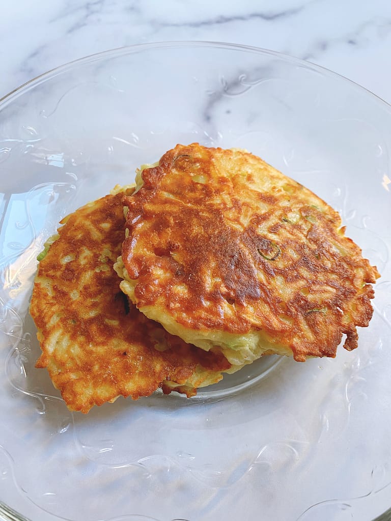 Two fried potato cakes, one on top of the other