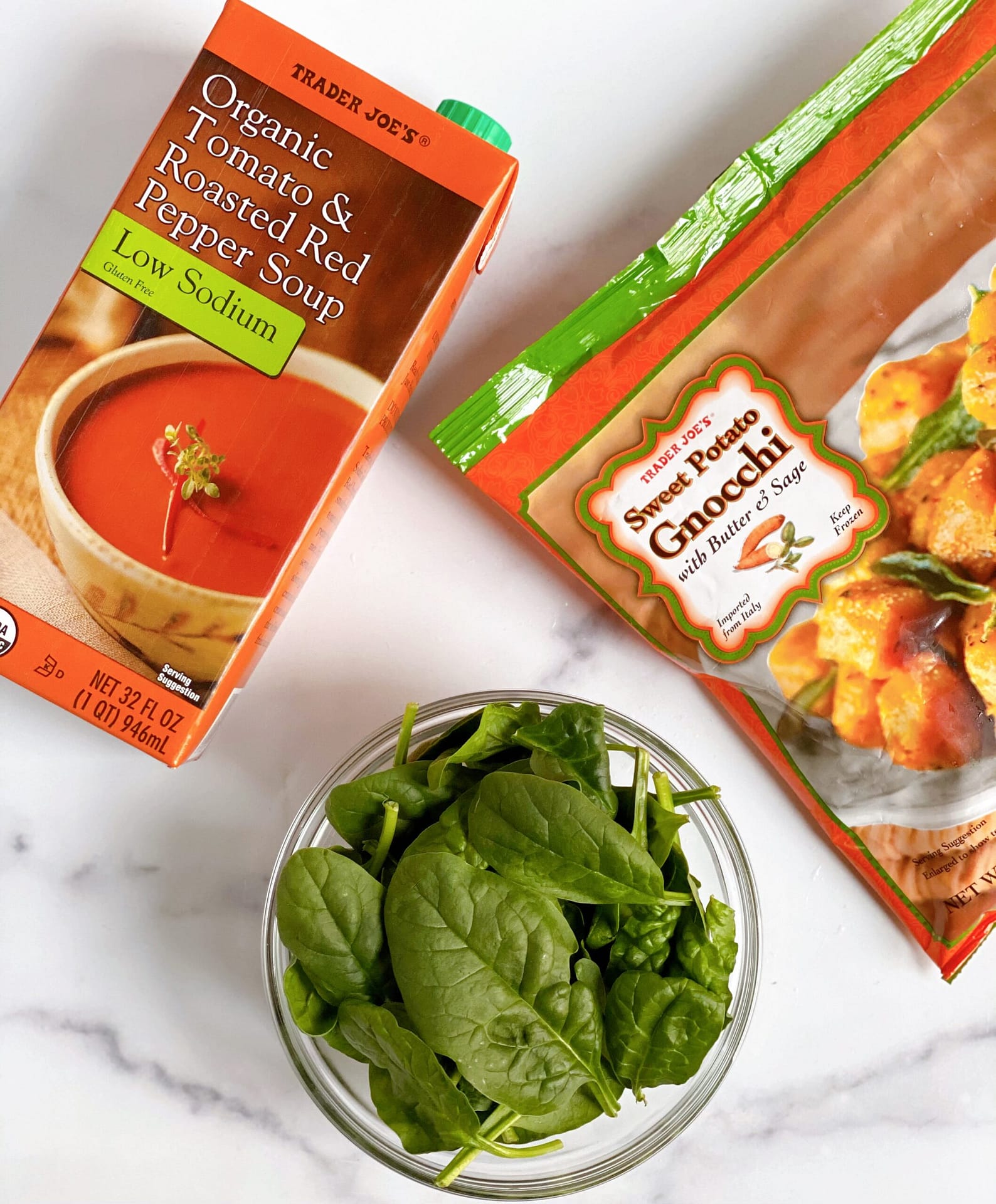 An overview shot of the ingredients needed for Butter & Sage Sweet Potato Gnocchi with Tomato Soup - Tomato Soup, Sweet Potato Gnocchi and Spinach
